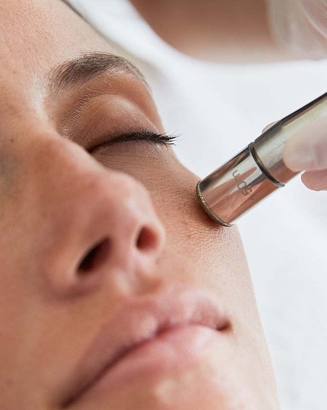 Facial treatment with a skincare device.