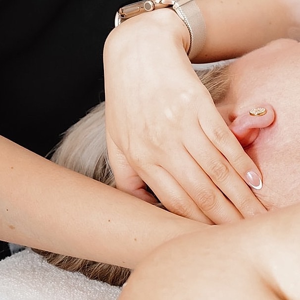 Facial treatment with steam application at spa.