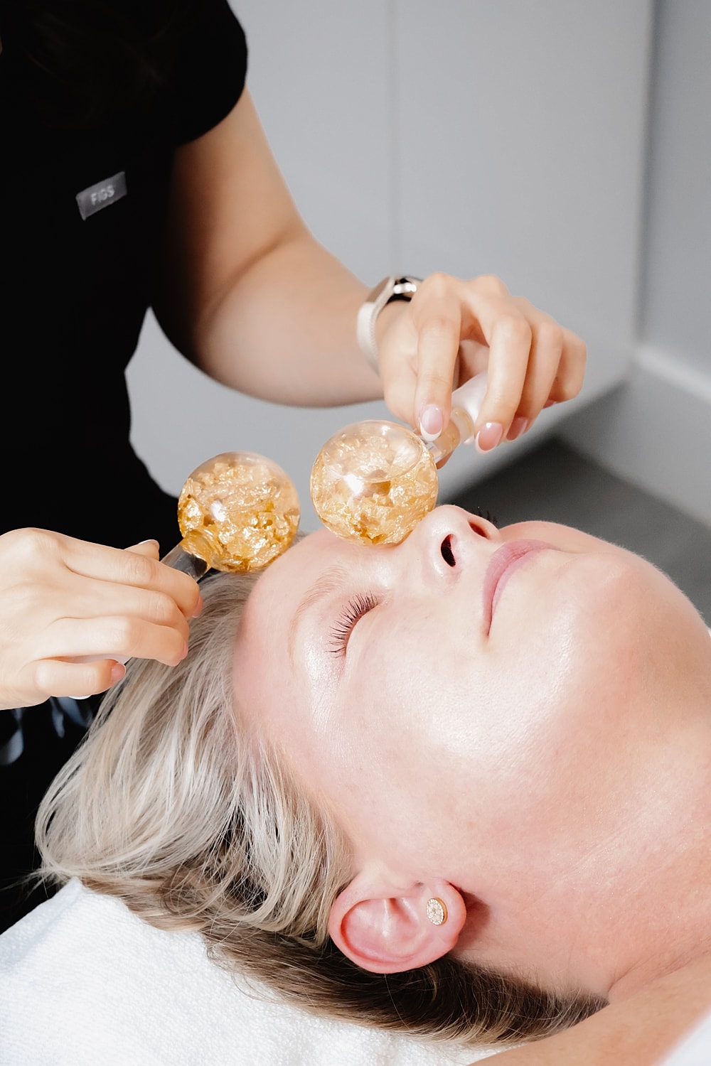 Facial treatment with glass cups on woman's face.