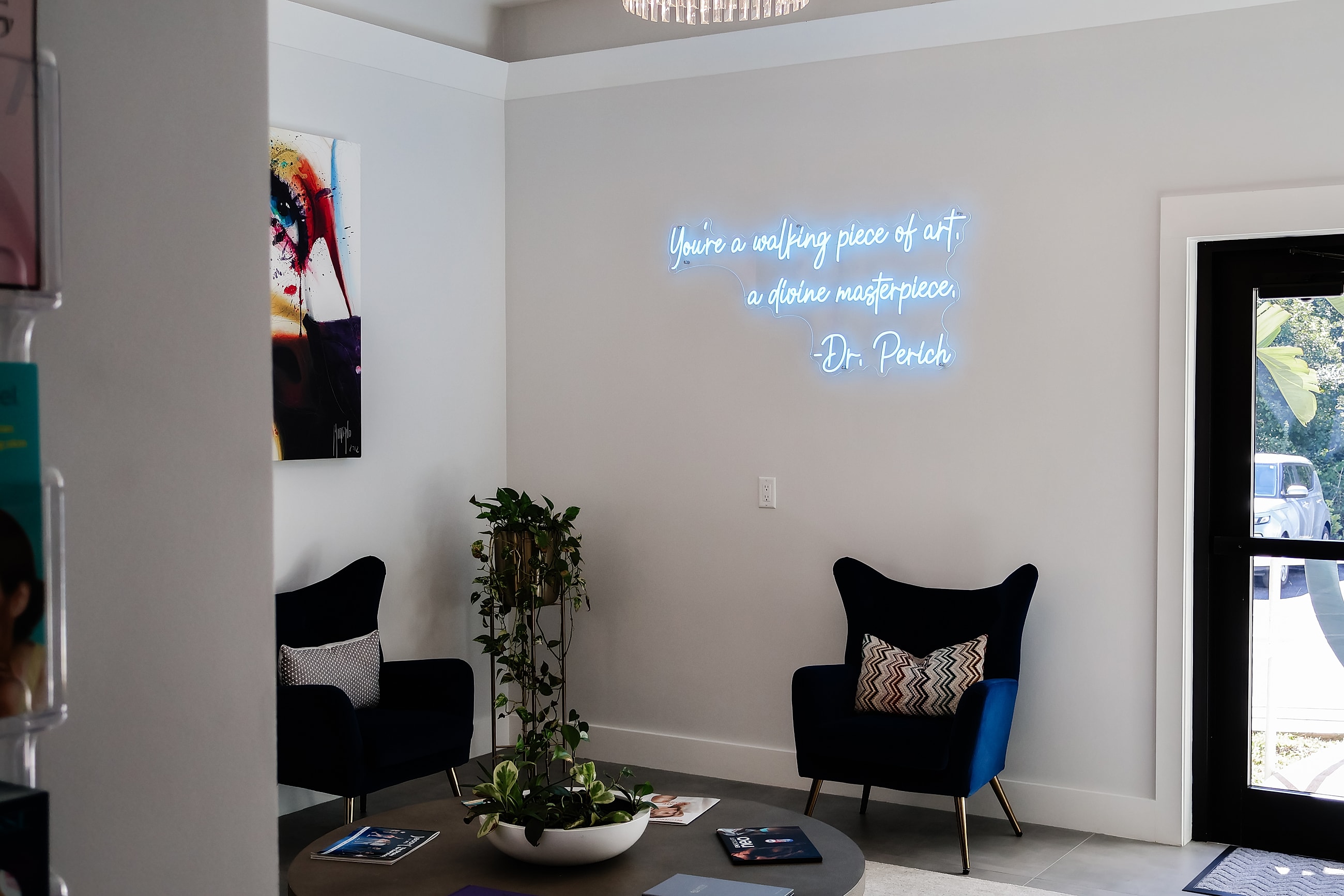 Cozy waiting area with inspirational neon sign.