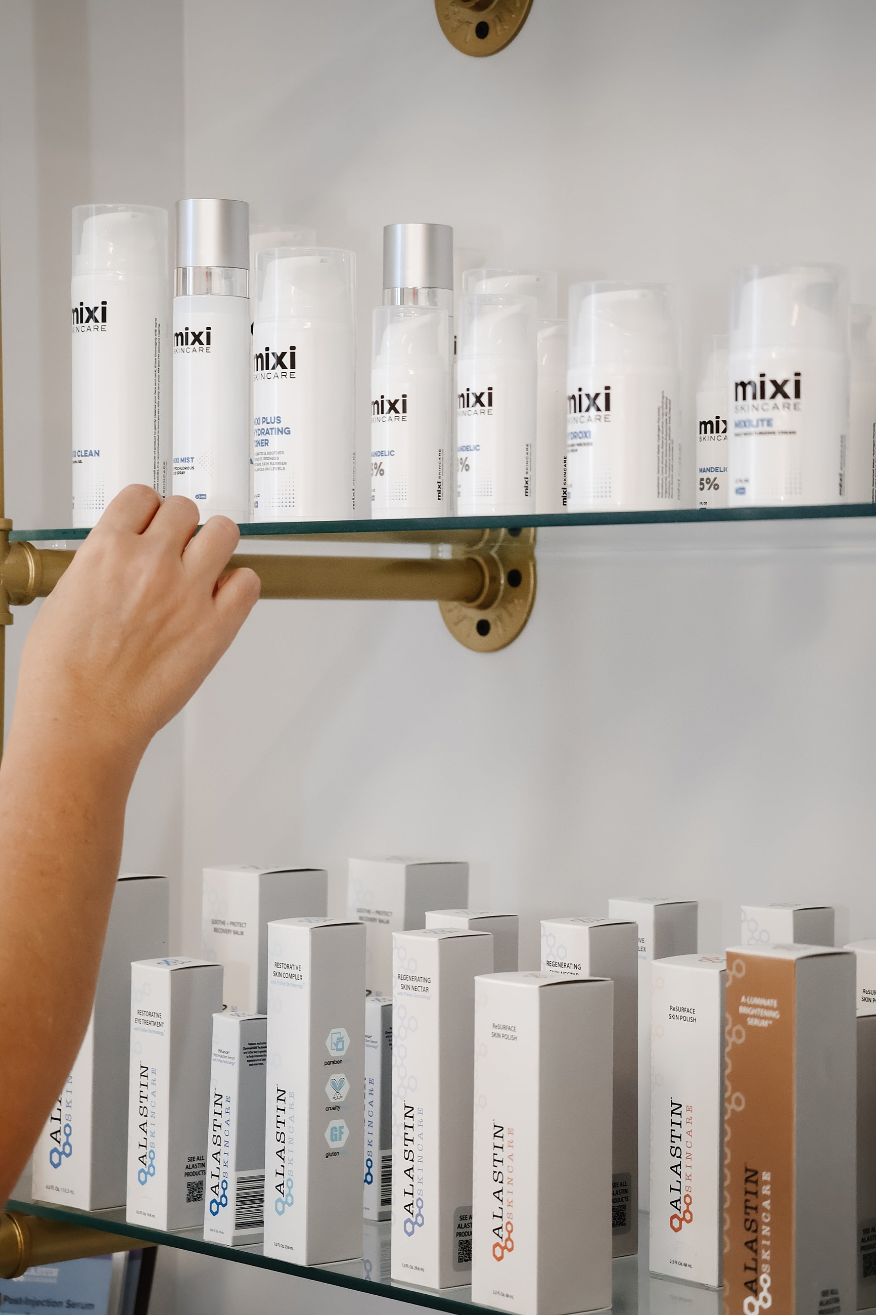 Skincare products displayed on a glass shelf.