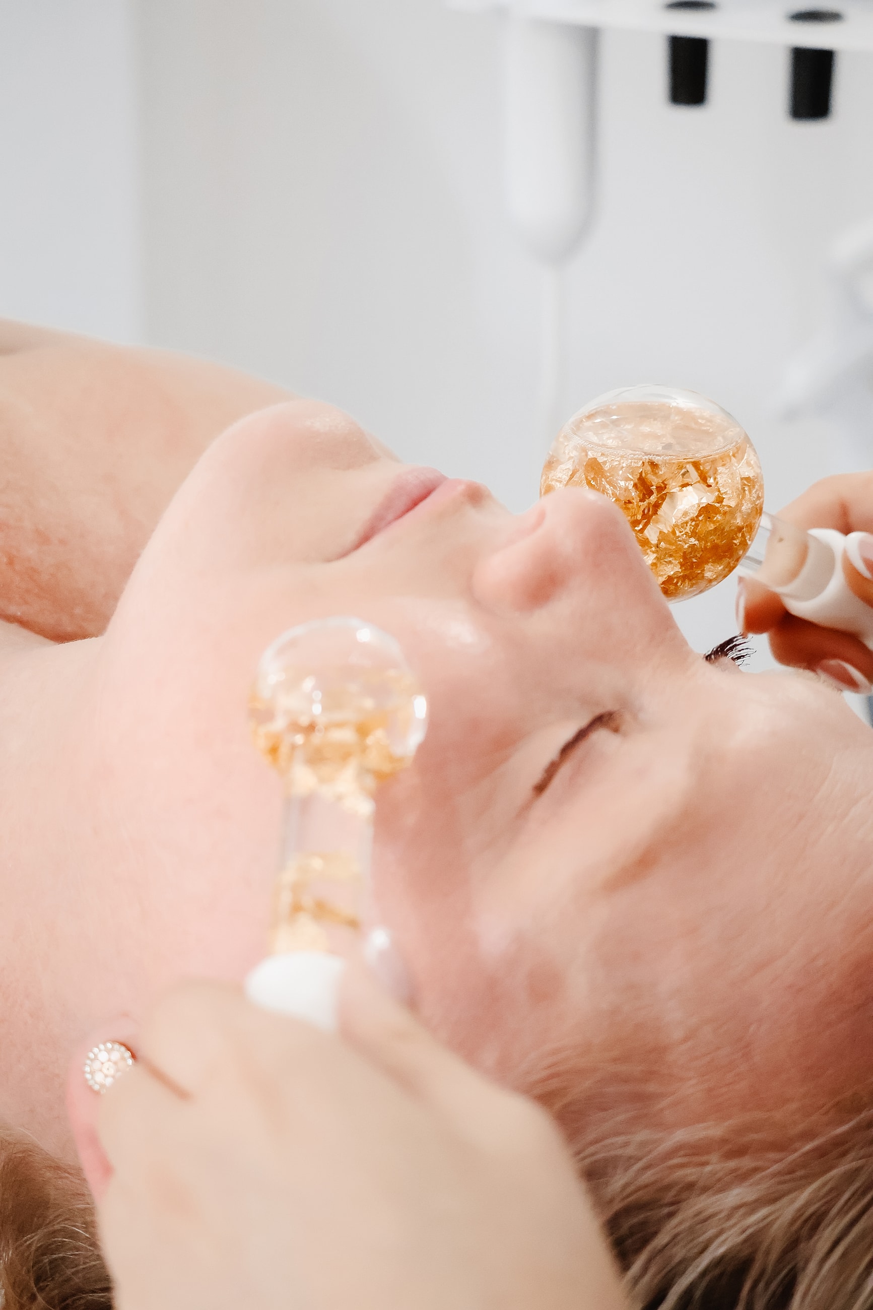 Skincare treatment with glass facial tools.