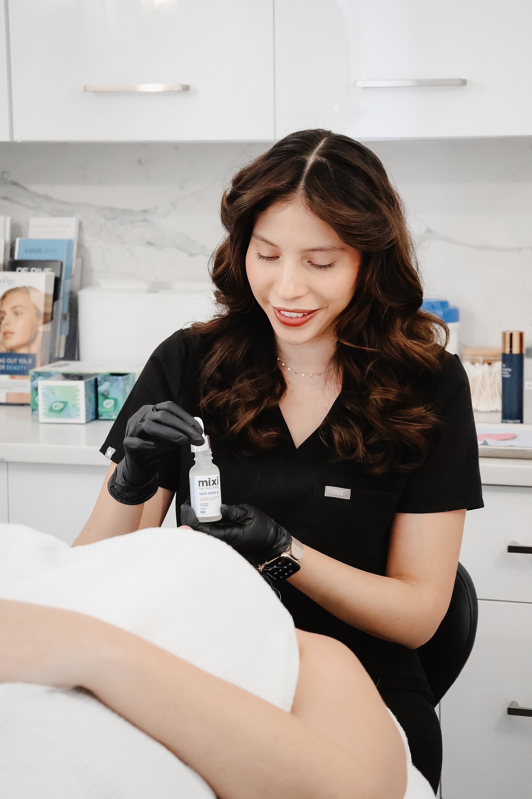 Skincare professional applying product to client’s skin.