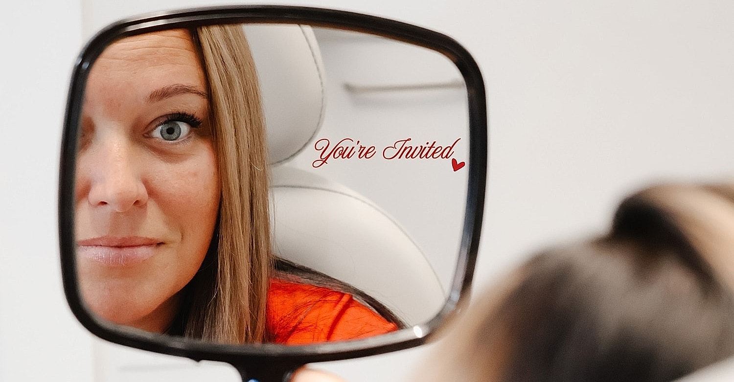 Group of smiling friends in white robes.